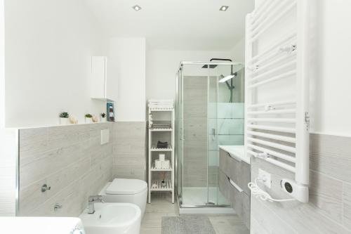 a bathroom with a shower and a toilet and a sink at Sea Loft Quinto - A due passi dal mare in Genoa
