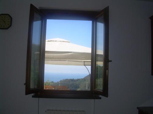 a window with a view of a boat at Ariabuona in Moneglia