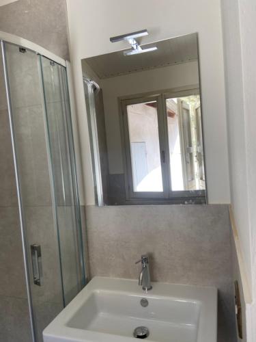 a bathroom with a sink and a shower and a mirror at Casa Bonacini in Reggio Emilia