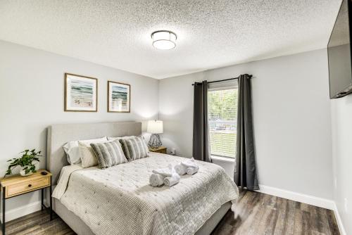 a bedroom with a bed with two teddy bears on it at Palm Coast Vacation Rental about 8 Mi to Flagler Beach in Flagler Beach