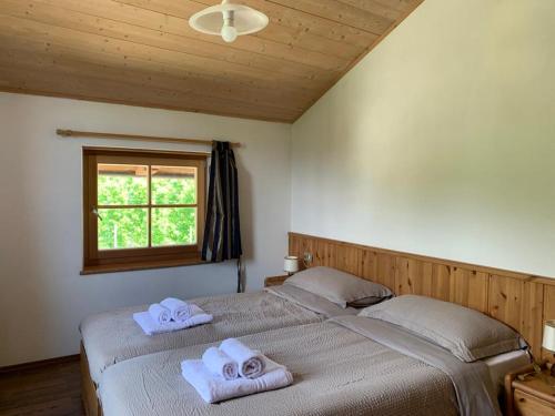 a bedroom with two beds with towels on them at Agritur Maso Forcola in Brez