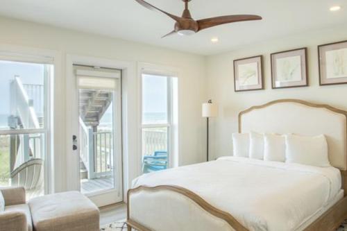 a bedroom with a bed and a ceiling fan at Aquarius in St. George Island