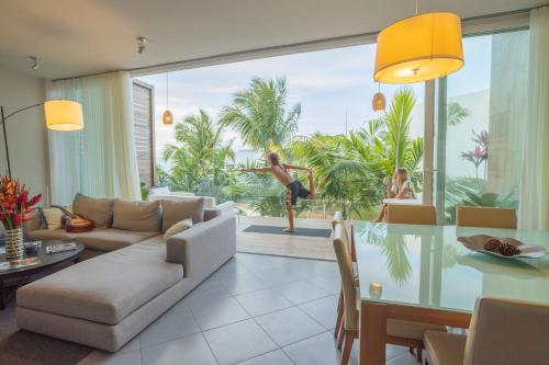 a living room with a couch and a table at Ultravioleta Boutique Residences in Cabarete