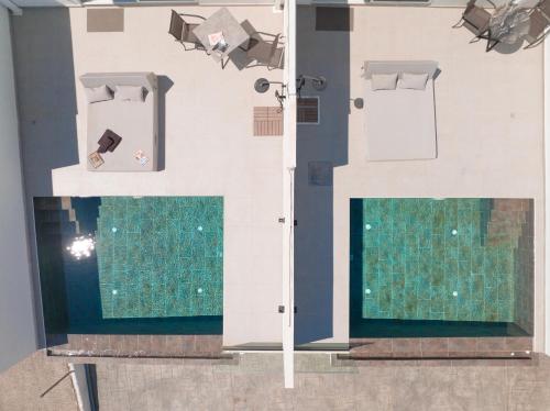 a room with two floors and a pool of water at Akrogiali Apartments in Barbati
