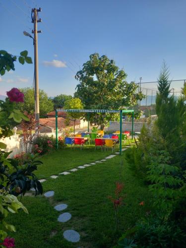 a garden with a gazebo and a table and chairs at Paradise House Hotel in Pamukkale