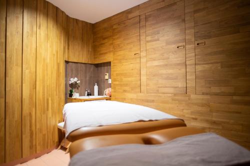 a bedroom with two beds and wooden walls at Amenity Hotel & Resort Lipno in Lipno nad Vltavou