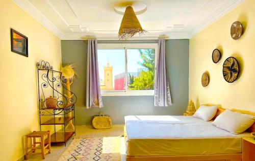 a bedroom with a bed and a window at Skate Surf Morocco - Tamraghazout in Agadir
