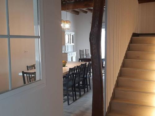a dining room and kitchen with a table and chairs at Casa Rural Triticum in Navas de Bureba