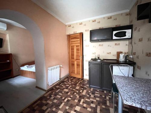 a kitchen with a sink and a counter in a room at Apart-Hotel City Center Contrabas in Lviv