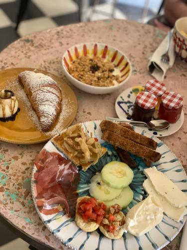 a table with plates of food on a table at HABITARE Lecce & Salento in Lecce