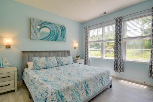 a bedroom with a bed and two windows at Barefoot Landing Retreat with Resort Amenities! in Myrtle Beach