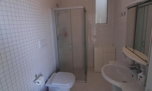 a bathroom with a shower and a toilet and a sink at Grazioso in Bibione