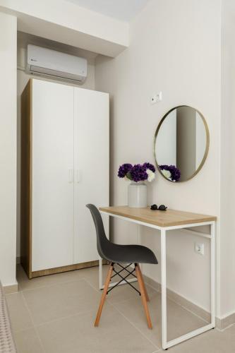 a desk with a chair and a mirror at V Luxury Apartments Siviri II in Siviri
