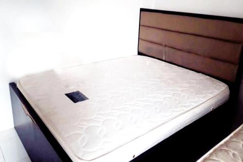 a bed with a white mattress on top of it at OYO Life 92647 Edelweis Homestay in Tuban