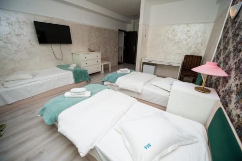 Ένα ή περισσότερα κρεβάτια σε δωμάτιο στο SIA Residence