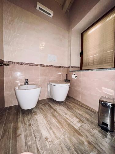 a bathroom with two white tubs and a sink at Chaledo Milagro in Ruino