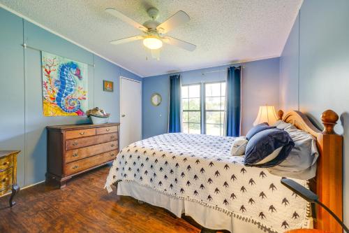 a bedroom with a bed and a ceiling fan at Secluded Hampstead Vacation Rental with Deck! in Surf City