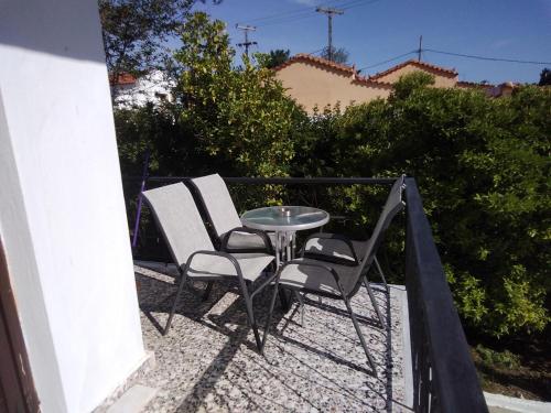 two chairs and a table on a balcony at Villa Ourania in Troulos