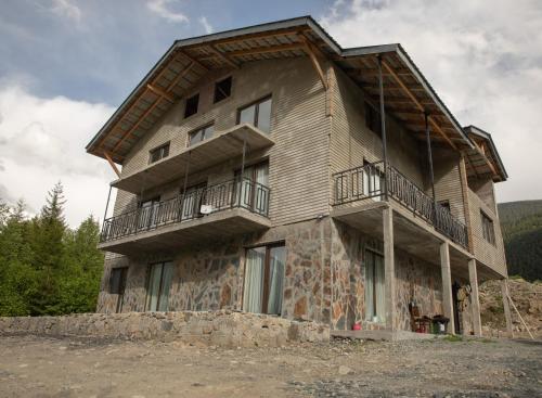 a large house with balconies on the side of it at "Panorama" Kakhri in Mestia