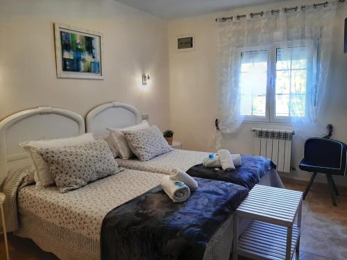 a bedroom with two beds with stuffed animals on them at Hotel Alvaro frente Palacio-Museo Selgas in Cudillero