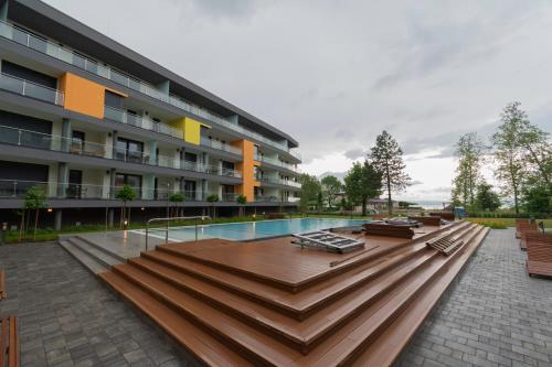 a large building with a swimming pool and a building at Római Panoráma apartman in Siófok