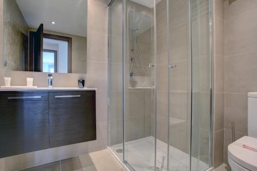 a bathroom with a glass shower and a toilet at Aqua Apartments Vento, Marbella in Marbella