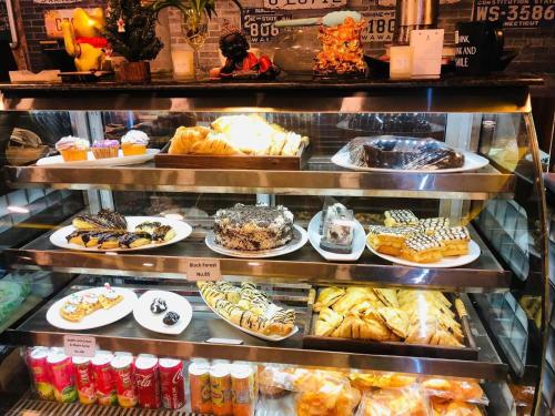 a display case in a bakery filled with lots of pastries at Silver Cloud Hotel in Paro