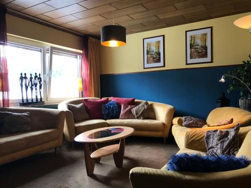 a living room with couches and a table at fun4all-holidayhome in Medebach
