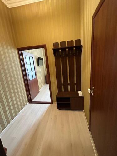 an empty hallway with a door and a room with a chair at Apart-Hotel City Center Contrabas in Lviv
