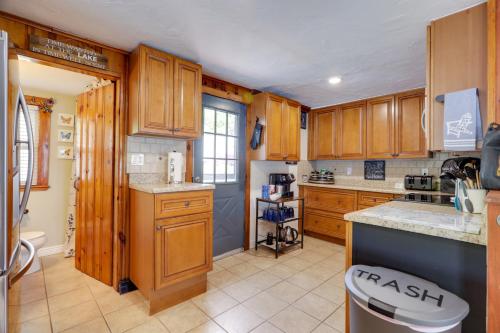 a kitchen with wooden cabinets and a counter top at Football Fans Lake Retreat - 5 Mins to Gillette! in Plainville