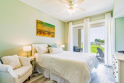 a bedroom with a bed and a couch and a window at Harbor Cove #111 in Orange Beach