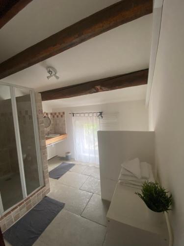 a living room with a window and a couch at Aux pieds tanques in Barbentane