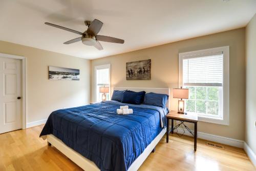 a bedroom with a blue bed and a ceiling fan at Harkers Island Vacation Rental with Pool Table! in Harkers Island