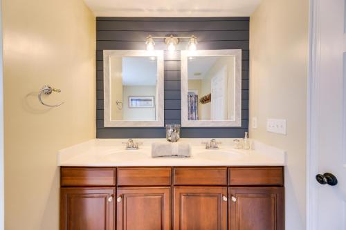 a bathroom with a sink and a mirror at Harkers Island Vacation Rental with Pool Table! in Harkers Island