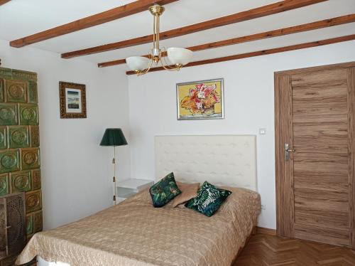 a bedroom with a bed and a ceiling at Apartament u Izy in Kazimierz Dolny
