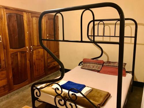 a black bunk bed in a room at Nomads nest safari house in Arusha