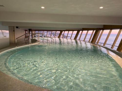 a large pool of water in a building at Intempo Gold&Gris Apartment in Benidorm