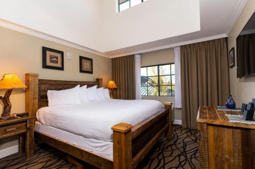 a bedroom with a large bed and a window at The Grand Hotel at the Grand Canyon in Tusayan