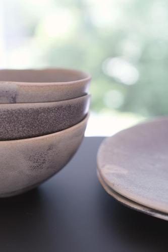 a stack of bowls sitting on a table at Eastside - Architect designed retreat with wood-fired sauna in Penicuik