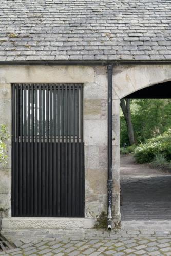 a building with a gate on the side of it at Eastside - Architect designed retreat with wood-fired sauna in Penicuik