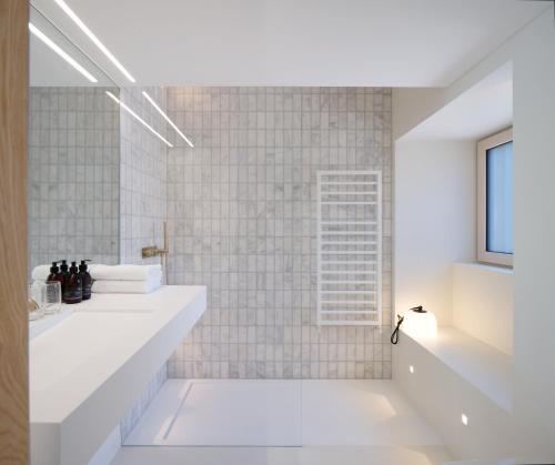 a white bathroom with a sink and a shower at Eastside - Architect designed retreat with wood-fired sauna in Penicuik