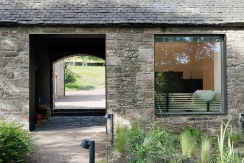 an entrance to a brick building with a doorway at Eastside - Architect designed retreat with wood-fired sauna in Penicuik