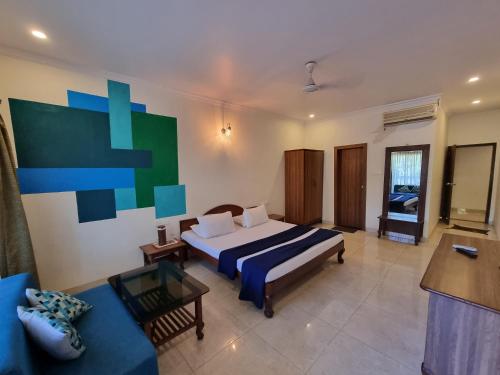 a large bedroom with a bed and a couch at Rishikesh Resort Lonavala in Lonavala