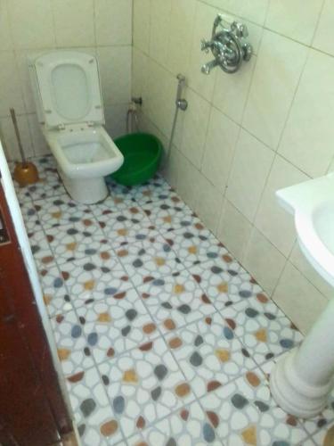 a bathroom with a toilet and a sink at City Max hotel Kabaale in Kabale