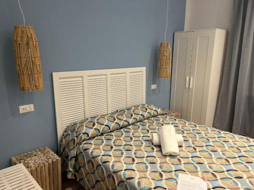 a bedroom with a bed with a white head board at Hotel Nice in Viareggio