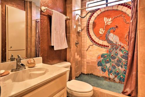 a bathroom with a toilet sink and a shower curtain at Exotic Home with Patio and Grill Walk to Canyon Lake! in Canyon Lake