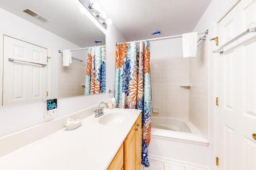 a bathroom with a sink and a shower curtain at Octopus Pond Paradise in Ocean City