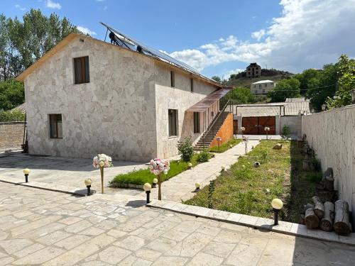 a stone house with a garden in front of it at White House-001 in Yeghegnadzor