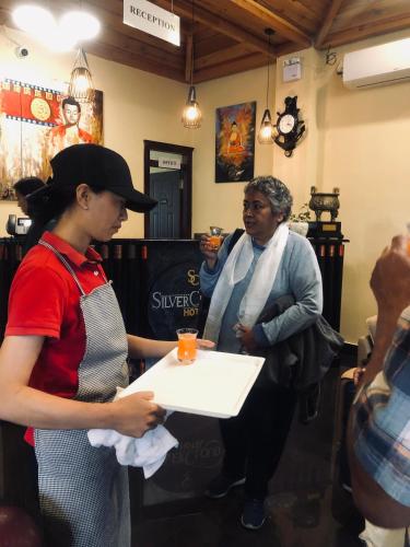 a woman and a man holding a piece of paper at Silver Cloud Hotel in Paro