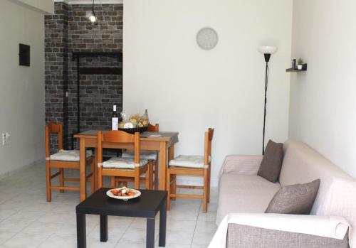 a living room with a table and a couch at Dabia Apartments in Mirina